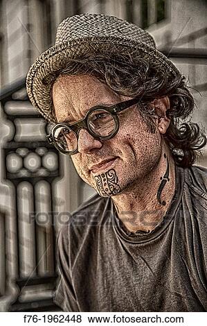 Portrait of a man wearing dark rimmed glasses with decorative, beard-like tatoos on his face. Harvard Yard, Harvard University View Large Photo Image Stock Photo - Portrait of a man wearing dark rimmed glasses with decorative, beard-like tatoos on his face. Harvard Yard, Harvard University. Fotosearch