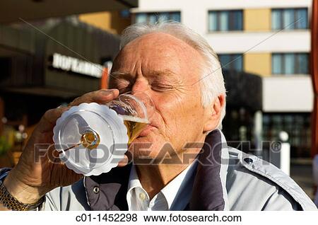Portrait of a mature man drinking a beer View Large Photo Image Stock Photo - Portrait of a mature man drinking a beer. Fotosearch