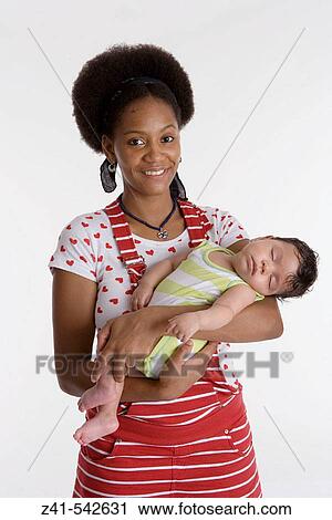 Portrait of a mother with a sleeping baby in her arms. View Large Photo Image Stock Image - Portrait of a mother with a sleeping baby in her arms.. Fotosearch