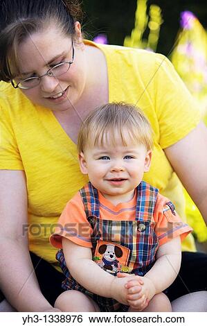 Stock Photograph - Portrait of a mother with her baby boy. Fotosearch