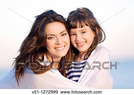 Portrait of a mother with her daughter smiling at the beach View Large Photo Image Stock Photo - Portrait of a mother with her daughter smiling at the beach. Fotosearch