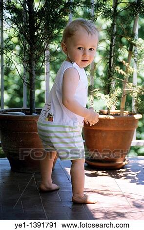 Portrait of a one year old baby girl on the balcony, France View Large Photo Image Stock Image - Portrait of a one year old baby girl on the balcony, France. Fotosearch