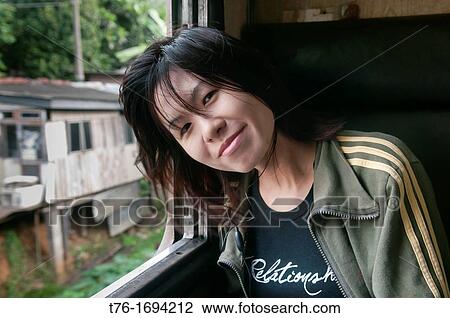 portrait of a pretty Asian woman traveling by train in Sri Lanka View Large Photo Image Stock Image - portrait of a pretty Asian woman traveling by train in Sri Lanka. Fotosearch