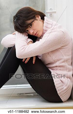 Portrait of a sad woman at home View Large Photo Image Stock Image - Portrait of a sad woman at home. Fotosearch