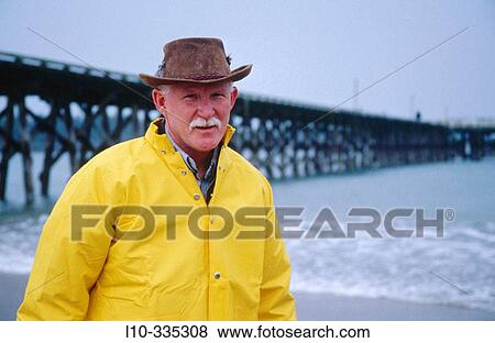 Portrait of a sand shrimp Fisherman with long pier in background. Winchester bay. Oregon. USA View Large Photo Image Stock Photo - Portrait of a sand shrimp Fisherman with long pier in background. Winchester bay. Oregon. USA. Fotosearch