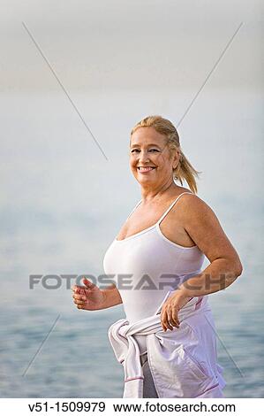 Portrait of a senior adult woman running at the beach View Large Photo Image Stock Photo - Portrait of a senior adult woman running at the beach. Fotosearch