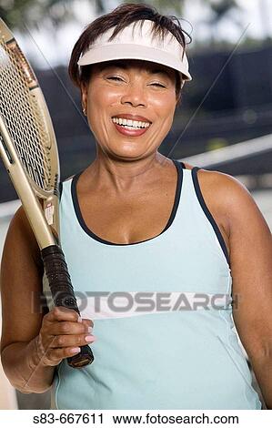 Portrait of a senior woman with a tennis racquet View Large Photo Image Stock Image - Portrait of a senior woman with a tennis racquet. Fotosearch