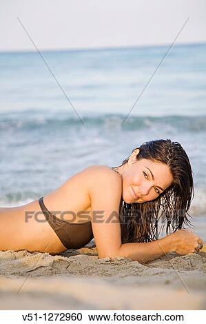 Portrait of a sensual brunette woman at the beach View Large Photo Image Stock Image - Portrait of a sensual brunette woman at the beach. Fotosearch