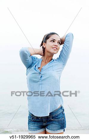Stock Photography - Portrait of a sensual brunette woman at the beach. Fotosearch