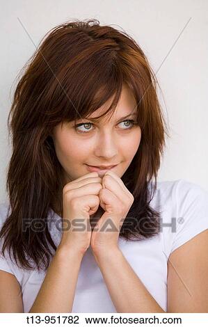 Portrait of a shy young brunette woman that is biting her lips View Large Photo Image Stock Image - Portrait of a shy young brunette woman that is biting her lips. Fotosearch