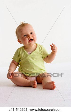 Stock Image - Portrait of a sitting blond baby girl.. Fotosearch