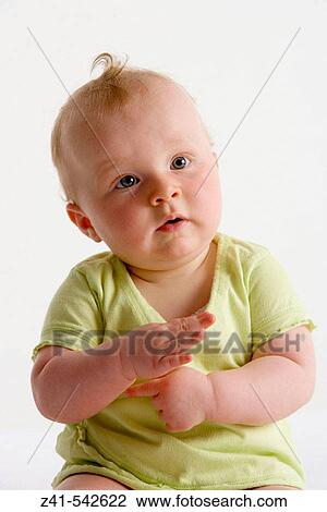 Portrait of a sitting blond baby girl. View Large Photo Image Stock Image - Portrait of a sitting blond baby girl.. Fotosearch