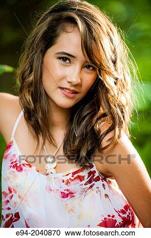 Portrait of a smiling 14 year old brunette girl in a summer dress in an outdoor setting. View Large Photo Image Stock Image - Portrait of a smiling 14 year old brunette girl in a summer dress in an outdoor setting.. Fotosearch