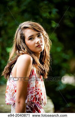 Portrait of a smiling 14 year old brunette girl in a summer dress in an outdoor setting. View Large Photo Image Stock Image - Portrait of a smiling 14 year old brunette girl in a summer dress in an outdoor setting.. Fotosearch
