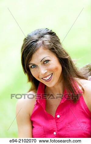 Portrait of a smiling 27 year old brunette woman looking at the camera, outdoors. View Large Photo Image Stock Image - Portrait of a smiling 27 year old brunette woman looking at the camera, outdoors.. Fotosearch