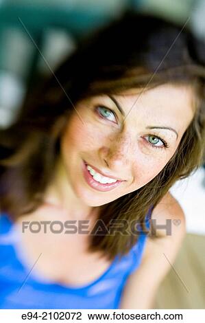 Portrait of a smiling 27 year old brunette woman looking at the camera, outdoors. View Large Photo Image Stock Image - Portrait of a smiling 27 year old brunette woman looking at the camera, outdoors.. Fotosearch