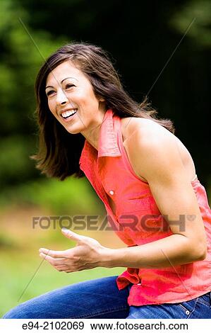 Portrait of a smiling 27 year old brunette woman looking looking away from the camera, outdoors. View Large Photo Image Stock Photo - Portrait of a smiling 27 year old brunette woman looking looking away from the camera, outdoors.. Fotosearch
