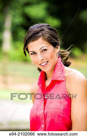 Portrait of a smiling 27 year old brunette woman looking at the camera, outdoors. View Large Photo Image Stock Photograph - Portrait of a smiling 27 year old brunette woman looking at the camera, outdoors.. Fotosearch