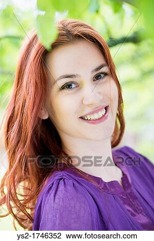 Portrait of a smiling young woman View Large Photo Image Stock Image - Portrait of a smiling young woman. Fotosearch