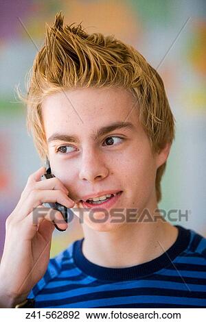 Stock Image - Portrait of a teenage boy with a phone. Fotosearch