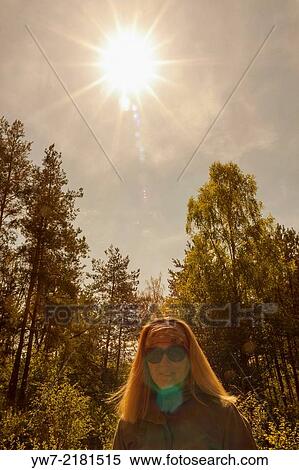 Stock Photography - Portrait of a woman against the sun.. Fotosearch