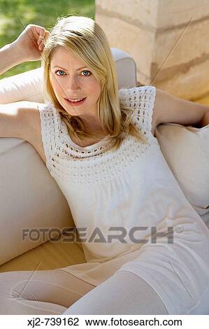 Stock Image - Portrait of a woman looking at camera calm. Fotosearch