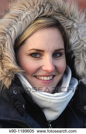Portrait of a woman, looking at the camera, visible teeth, and wearing a winter coat, Hamburg, Germany, Europe View Large Photo Image Stock Photography - Portrait of a woman, looking at the camera, visible teeth, and wearing a winter coat, Hamburg, Germany, Europe. Fotosearch