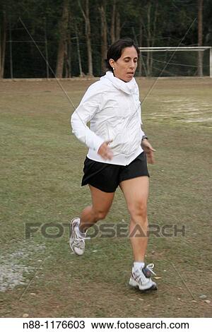 Portrait of a woman running View Large Photo Image Stock Image - Portrait of a woman running. Fotosearch