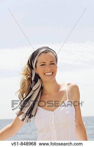 Portrait of a woman smiling by the sea View Large Photo Image Stock Photo - Portrait of a woman smiling by the sea. Fotosearch