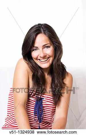 Stock Photo - Portrait of a woman smiling with brace. Fotosearch