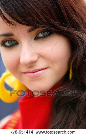 Picture - Portrait of a woman wearing traditional flamenco dress during the April Fair, Seville, Spain.. Fotosearch