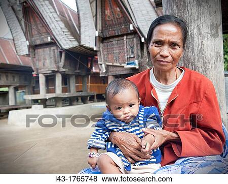 Stock Photo - Portrait of a woman with her daughter in Indonesia. Fotosearch