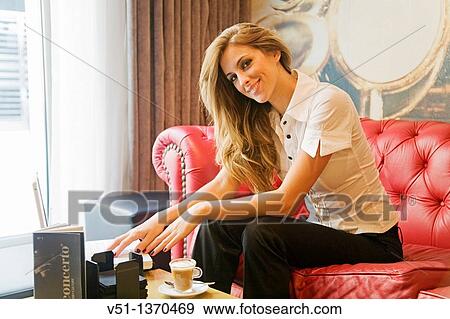 Portrait of a woman with laptop in a Cafe looking at camera View Large Photo Image Stock Photo - Portrait of a woman with laptop in a Cafe looking at camera. Fotosearch