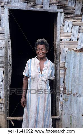 Stock Image - Portrait of a woman woman standing-up outside her home, Lonorore Village, Pentecost Island, Vanuatu. Fotosearch