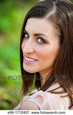 Portrait of a young a 22 year old brunette woman wearing a dress in a garden setting View Large Photo Image Stock Photo - Portrait of a young a 22 year old brunette woman wearing a dress in a garden setting. Fotosearch