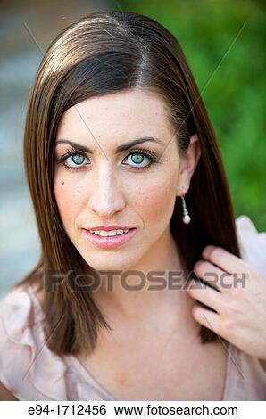 Portrait of a young a 22 year old brunette woman wearing a dress in a garden setting View Large Photo Image Stock Photograph - Portrait of a young a 22 year old brunette woman wearing a dress in a garden setting. Fotosearch