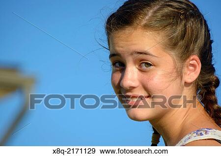Portrait of a young American Caucasian girl looking back at the camera. View Large Photo Image Stock Photo - Portrait of a young American Caucasian girl looking back at the camera.. Fotosearch