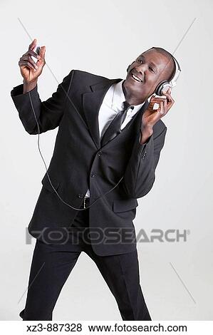 Stock Photo - Portrait of a young black man listening to music. Fotosearch