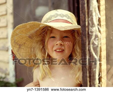 Portrait of a young blond girl in her straw sun bonnet at her back door as the sun sprinkles little highlights on her nose View Large Photo Image Stock Photograph - Portrait of a young blond girl in her straw sun bonnet at her back door as the sun sprinkles little highlights on her nose. Fotosearch