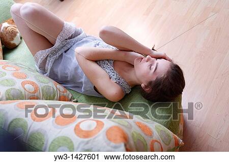 Portrait of a young blond woman lying on sofa View Large Photo Image Stock Image - Portrait of a young blond woman lying on sofa. Fotosearch