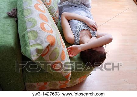 Portrait of a young blond woman lying on sofa View Large Photo Image Stock Image - Portrait of a young blond woman lying on sofa. Fotosearch