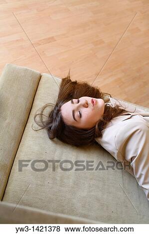 Portrait of a young blond woman lying on sofa View Large Photo Image Stock Photo - Portrait of a young blond woman lying on sofa. Fotosearch