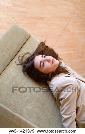 Portrait of a young blond woman lying on sofa View Large Photo Image Stock Photo - Portrait of a young blond woman lying on sofa. Fotosearch
