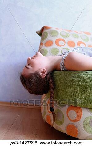 Portrait of a young blond woman lying on sofa View Large Photo Image Stock Photo - Portrait of a young blond woman lying on sofa. Fotosearch