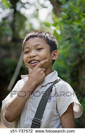 Portrait of a young boy after school in Luang Prabang, Laos View Large Photo Image Stock Image - Portrait of a young boy after school in Luang Prabang, Laos. Fotosearch