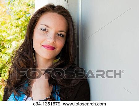 Portrait of a young brunette woman smiling at the camera View Large Photo Image Stock Photo - Portrait of a young brunette woman smiling at the camera. Fotosearch