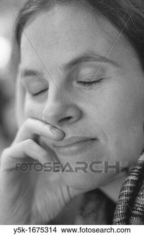 Portrait of a young, caucasian female, leaning on her right-hand. Scanned from black-and-white film. View Large Photo Image Picture - Portrait of a young, caucasian female, leaning on her right-hand. Scanned from black-and-white film.. Fotosearch