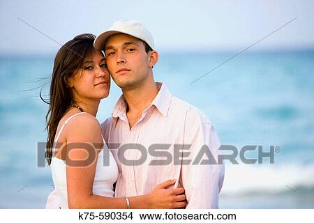 Portrait of a young couple at the beach View Large Photo Image Picture - Portrait of a young couple at the beach. Fotosearch
