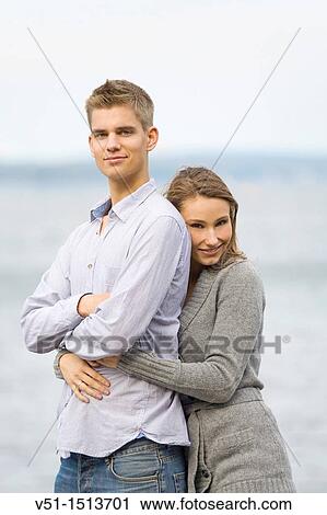 Portrait of a young couple embraced by the sea View Large Photo Image Stock Image - Portrait of a young couple embraced by the sea. Fotosearch