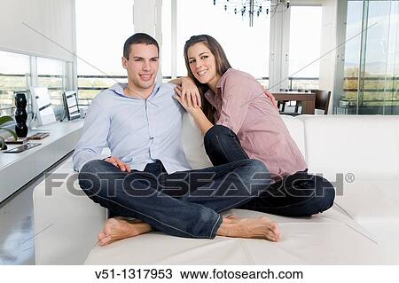 Portrait of a young couple in sofa View Large Photo Image Stock Image - Portrait of a young couple in sofa. Fotosearch